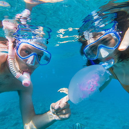couple diving underwater